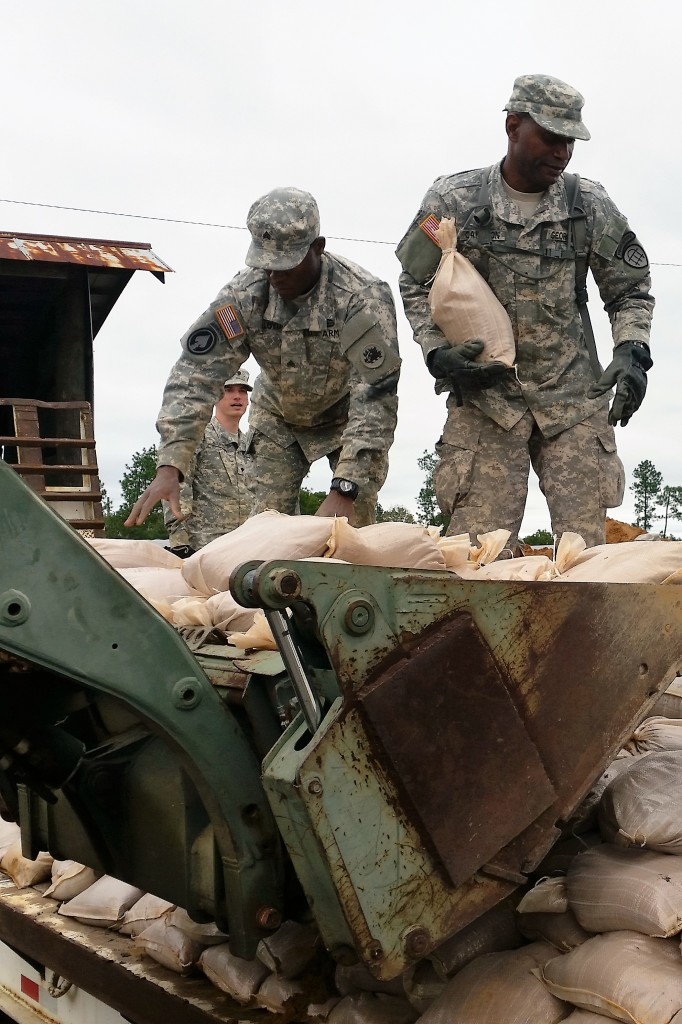 Georgia Army National Guard and Georgia State Defense Force Soldiers work together to load sandbags onto a flatbed truck as part of hurricane relief efforts near Augusta, Georgia. (Georgia State Defense Force photo by Chief Warrant Officer 2 W. Kevin Ward, 1BDE, AS3.)